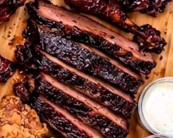Slices of smoked brisket with a dark bark on a wooden board