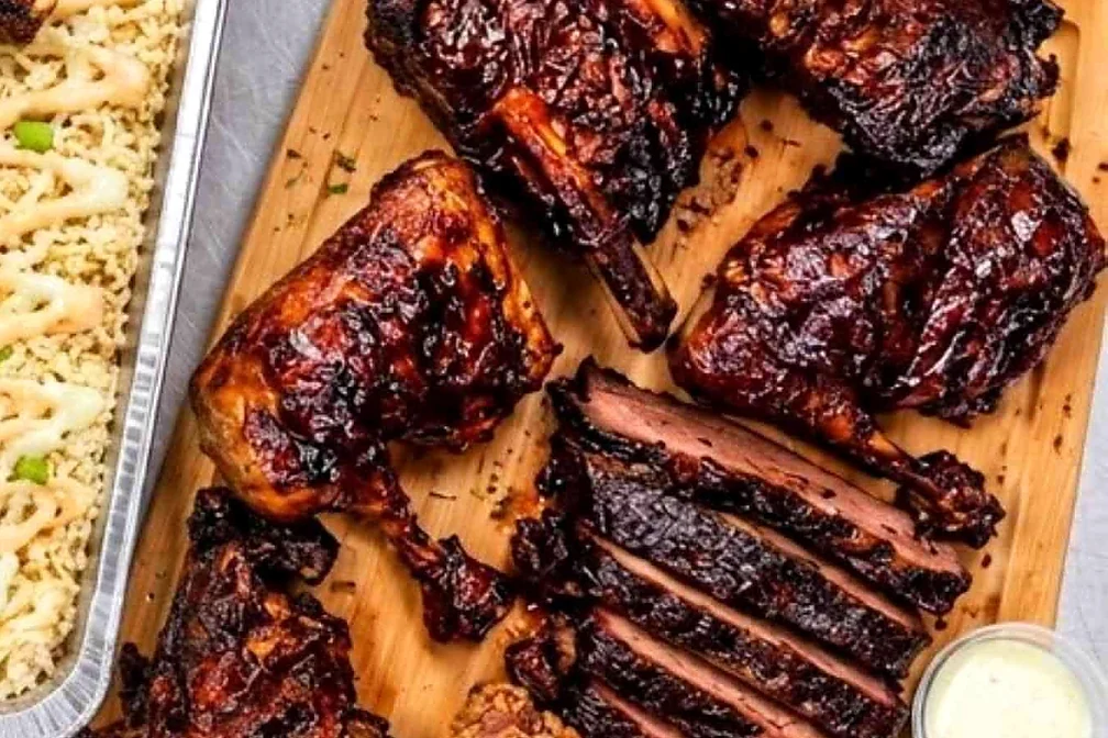 Platter for 2 with ribs, a smoked chicken leg, sliced smoked beef, fried chicken and fries